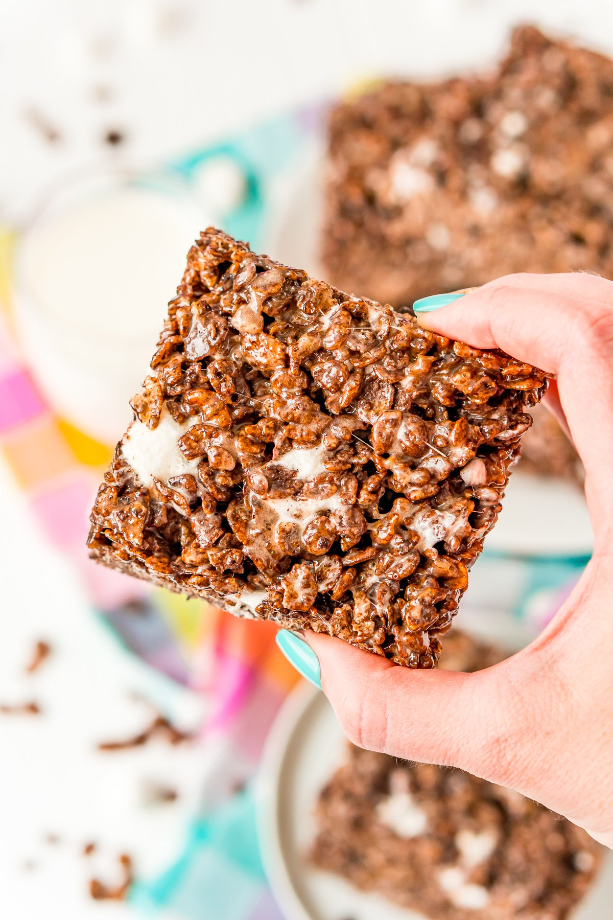 Woman's hand holding a chocolate rice krispie treat.