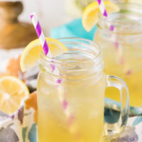 Mason jar with handle filled with a beer cocktail recipe.