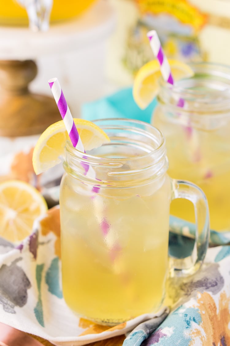 Mason jar with handle filled with a beer cocktail recipe.