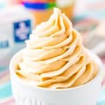 Close up photo of peanut butter cream cheese frosting piped into a small white bowl.