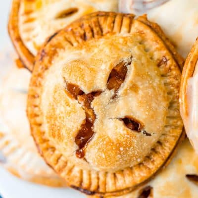 A white plate filled with apple hand pies.