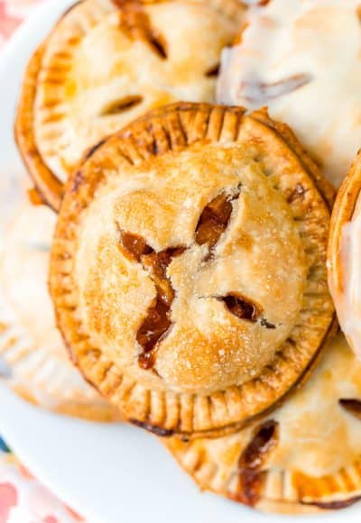 A white plate filled with apple hand pies.