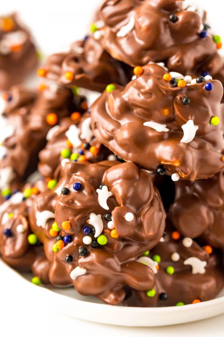 Chocolate candies with halloween sprinkles on a white plate.