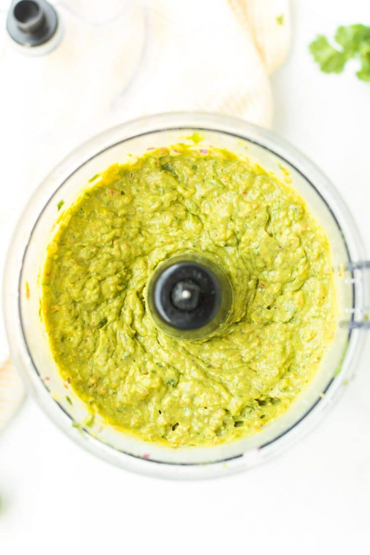 Overhead photo of guacamole in a food processor.