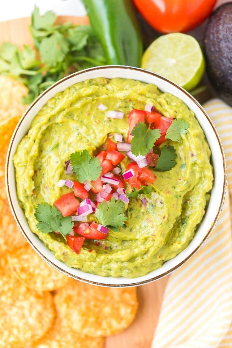 Overhead photo of a bowl of guacamole served with tortilla chips.