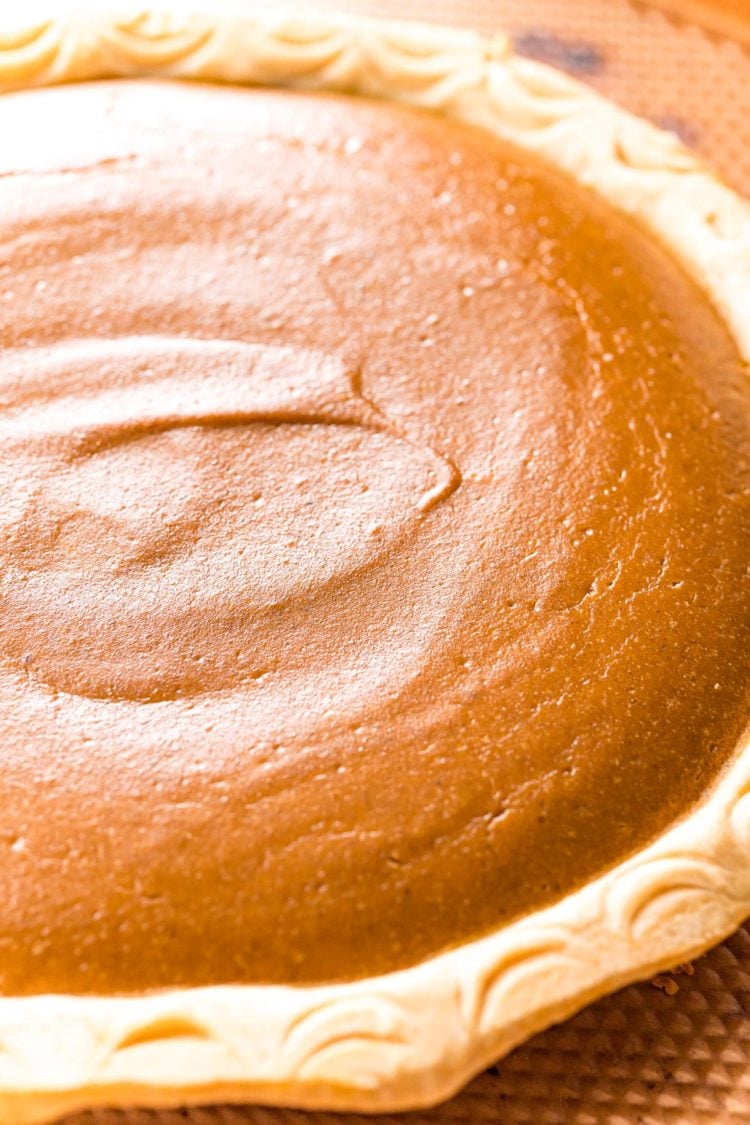 Close up photo showing what a pumpkin pie should look like when it's done baking.