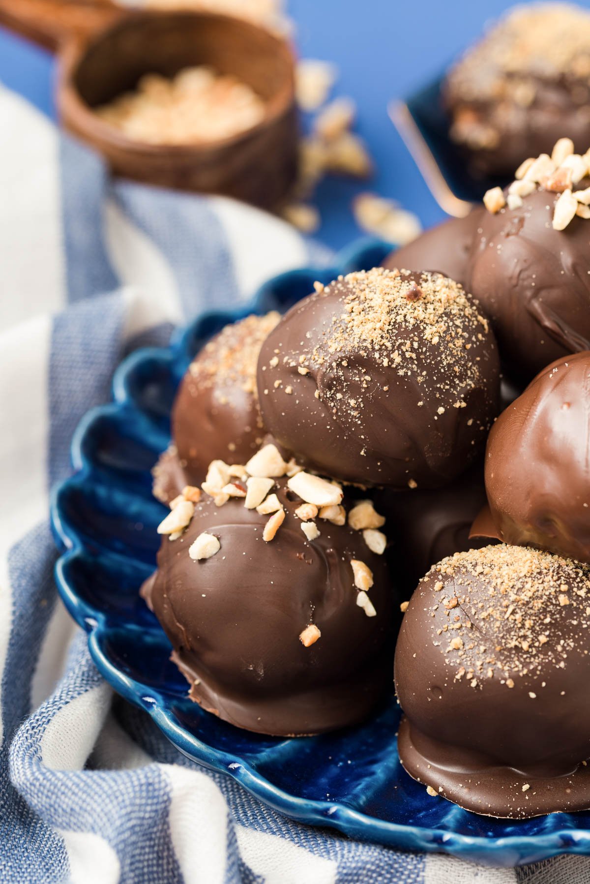 Peanut butter balls on a blue plate.