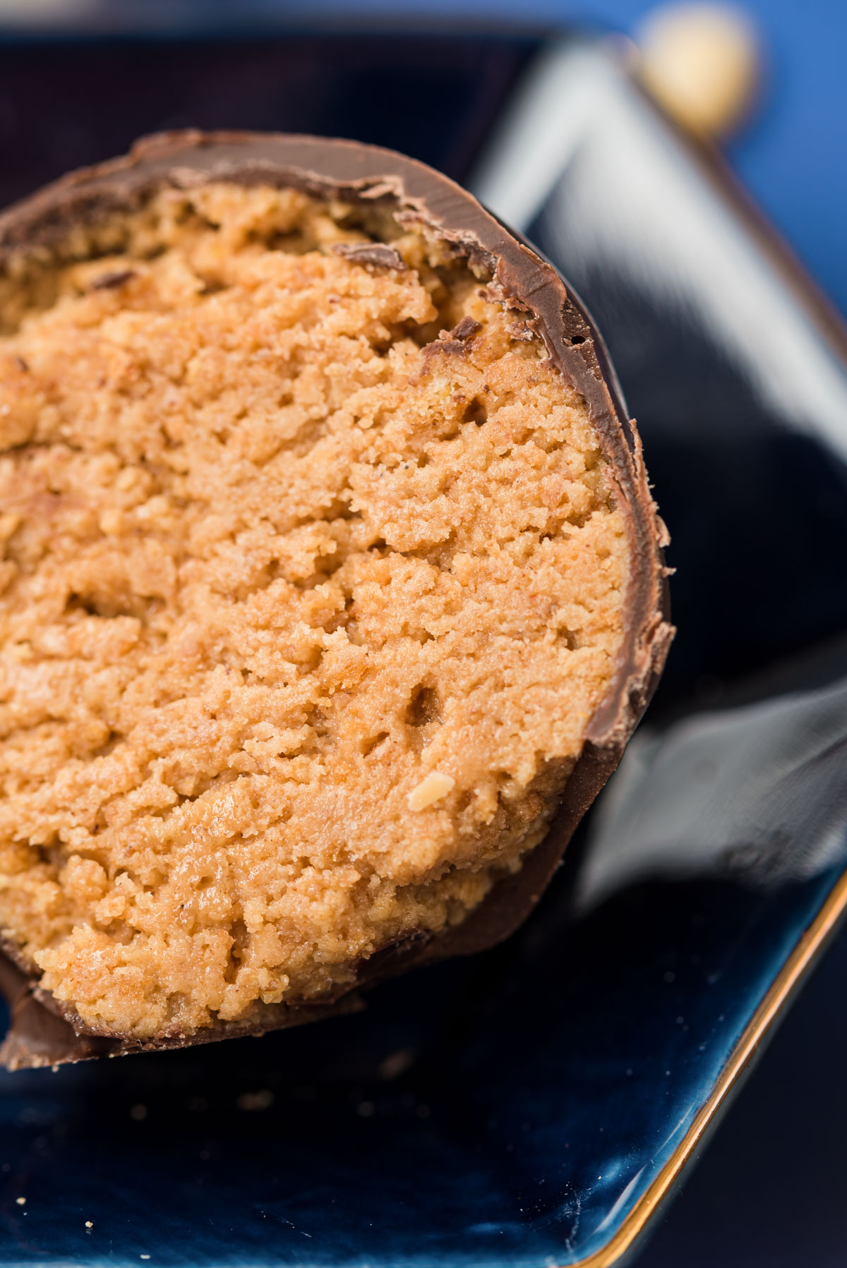 Close up photo of a peanut butter ball that has been cut in half.