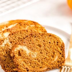 Slices of pumpkin bread on a white plate.