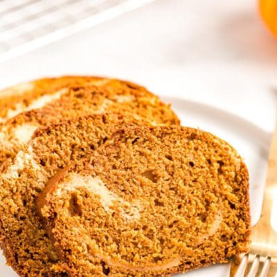 Slices of pumpkin bread on a white plate.