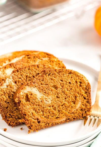 Slices of pumpkin bread on a white plate.