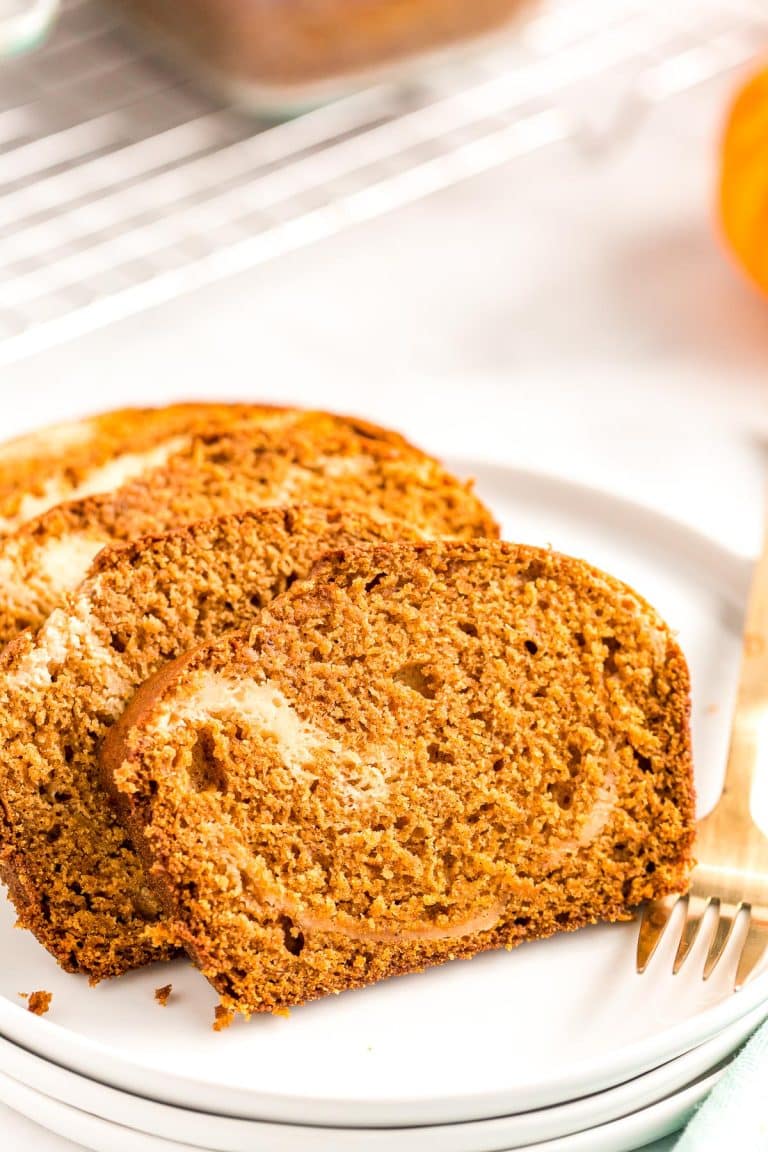 Slices of pumpkin bread on a white plate.