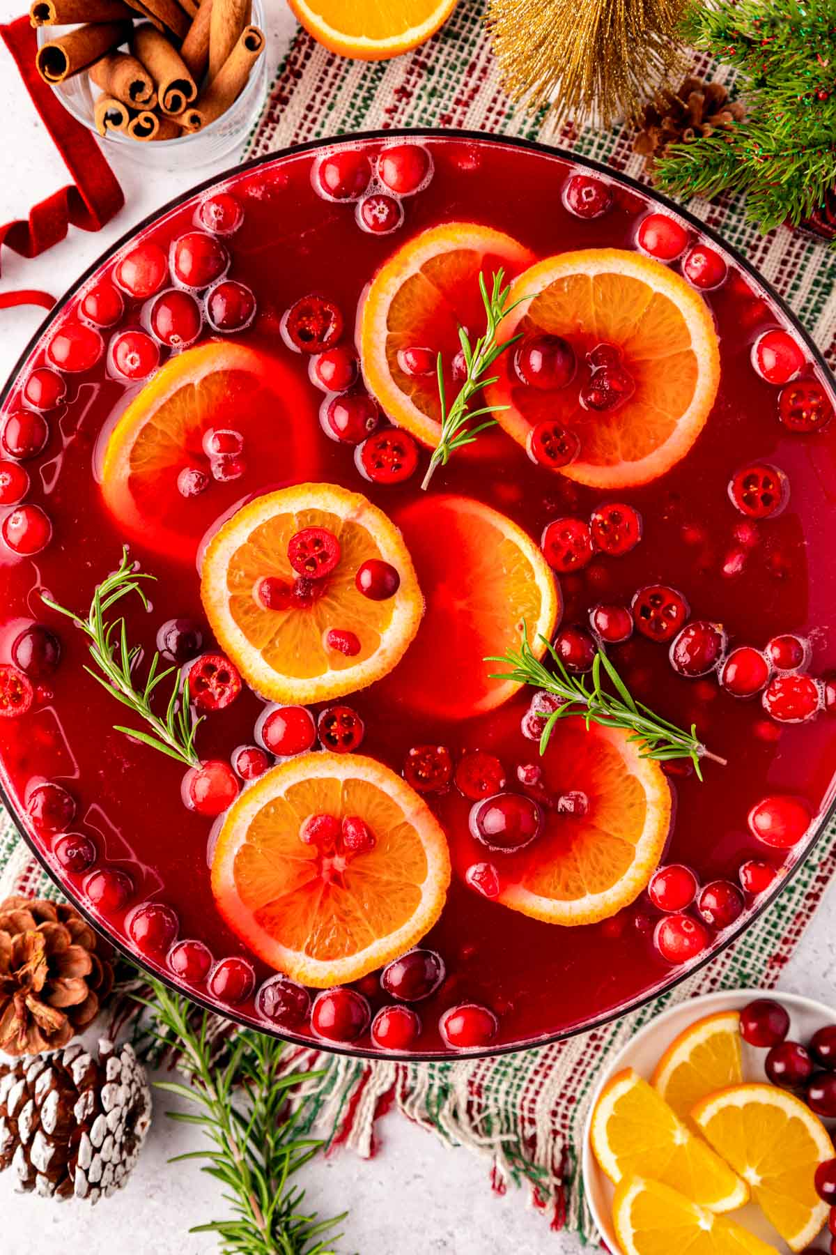Overhead photo of a bowl of Christmas Punch on a table ready for a party.