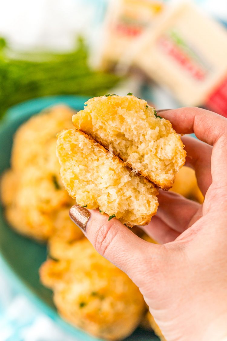 A cheese biscuit broken in half showing the texture.