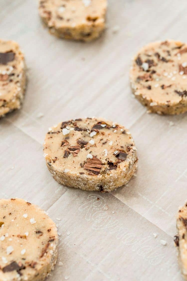 Sliced chocolate chunk cookies on a baking sheet ready to be baked. 