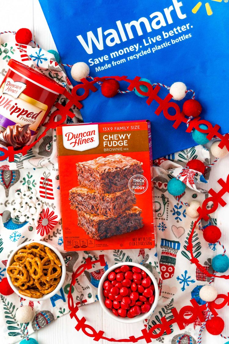 A box of Duncan Hines Brownie Mix and other baking ingredients on a table with a Walmart reusable bag.