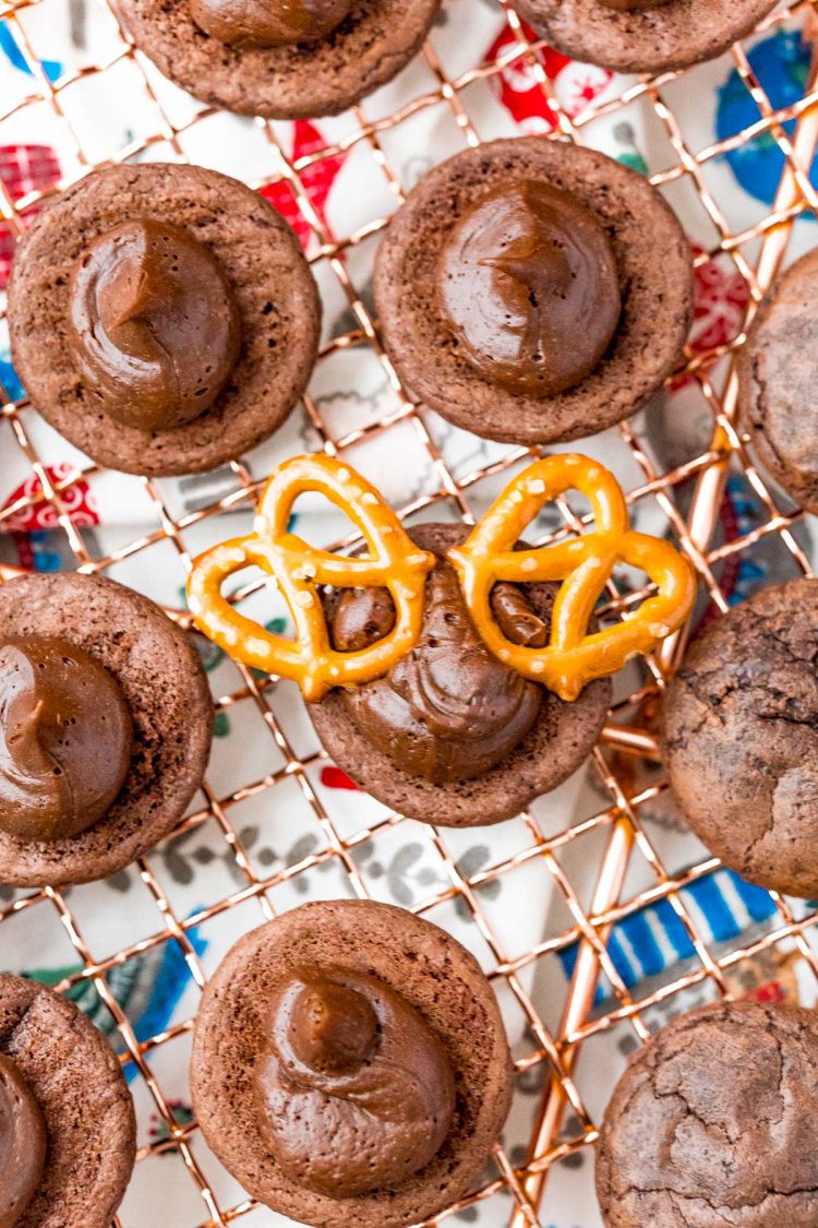 Pretzel placed in frosting on chocolate cookies to make reindeer cookies.