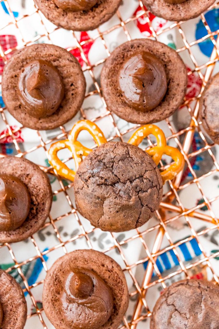 Brownie cookies sandwiching mini pretzels to make antlers for reindeer cookies