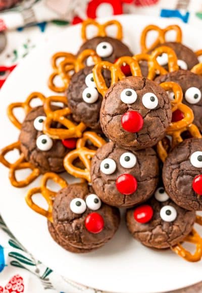 Reindeer Cookies stacked on top of each other on a white plate.