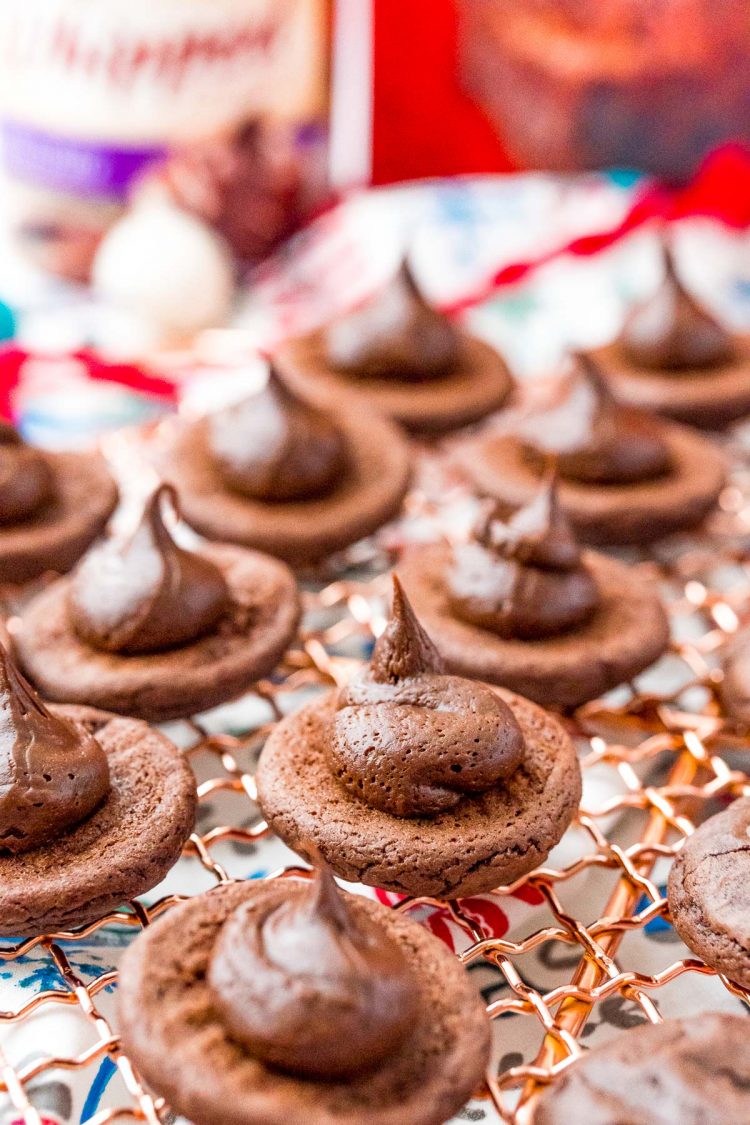 Brownie cookies with frosting piped onto the bottom.