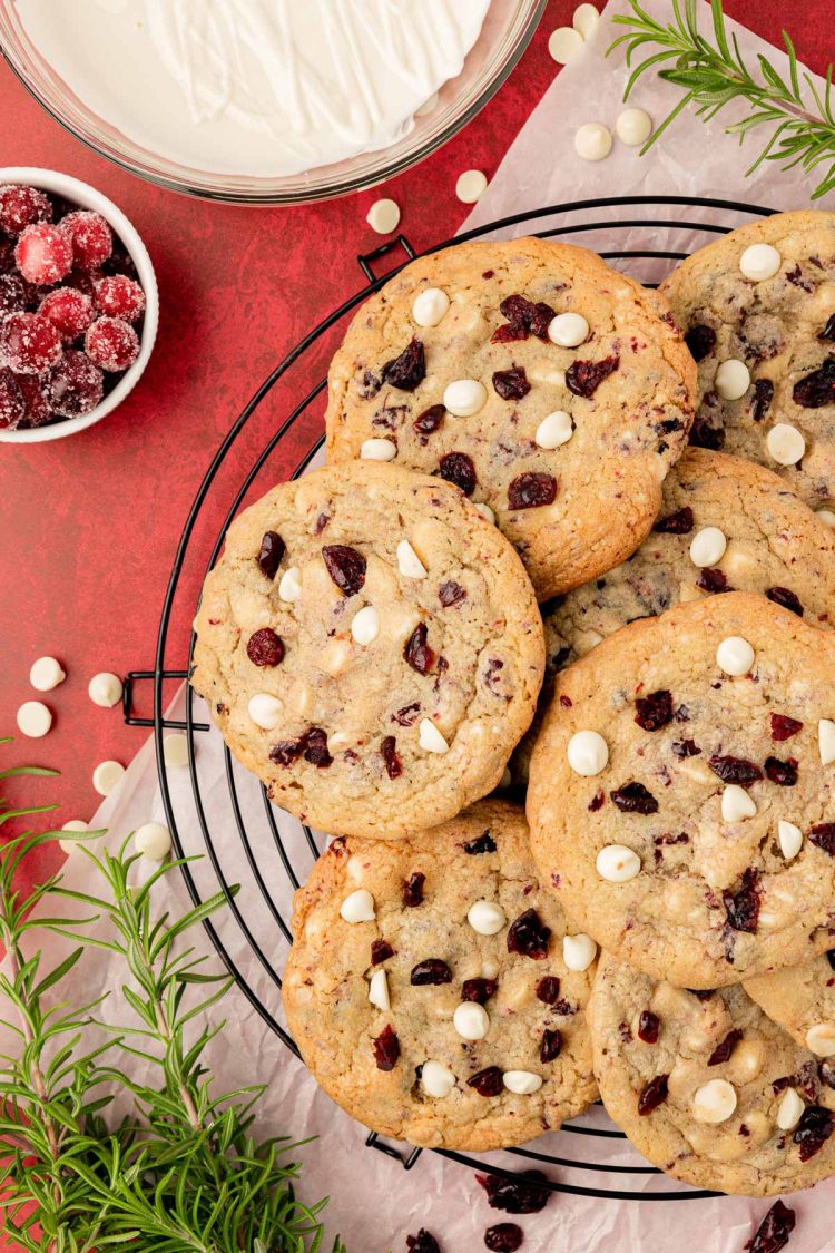 Cranberry white chocolate cookies on a wire rack.