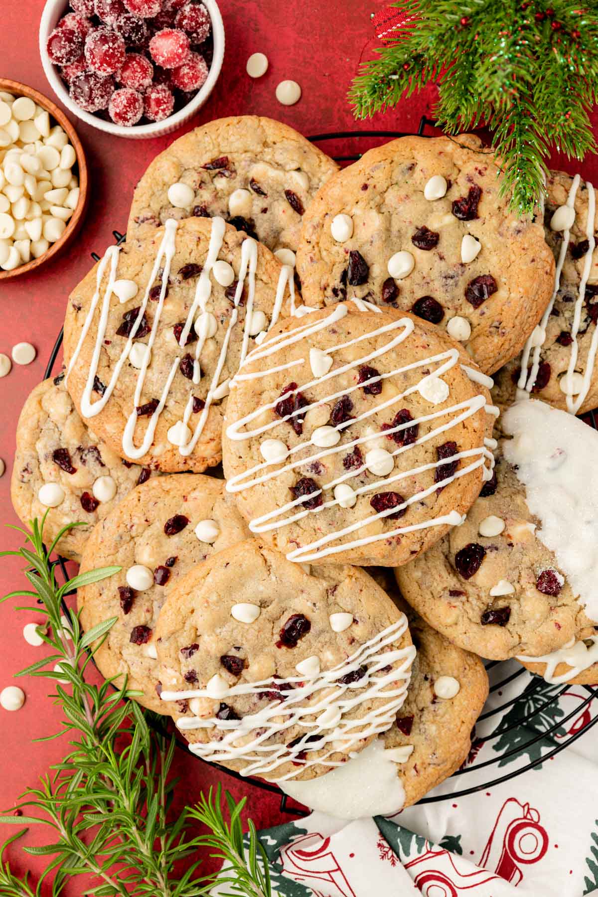Overhead photo of a wire rack with cranberry white chocolate cookies on it.