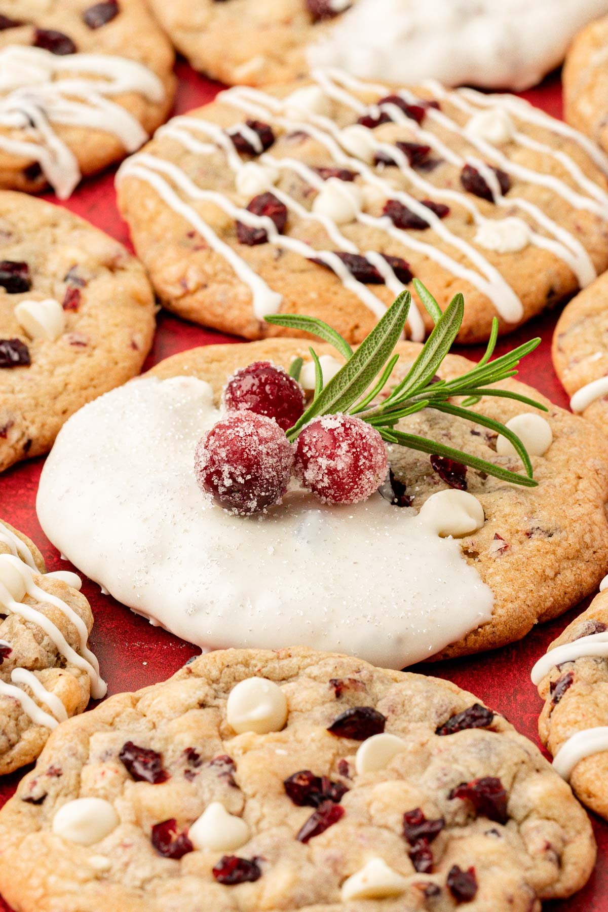 Cranberry white chocolate chip cookies on a red table.