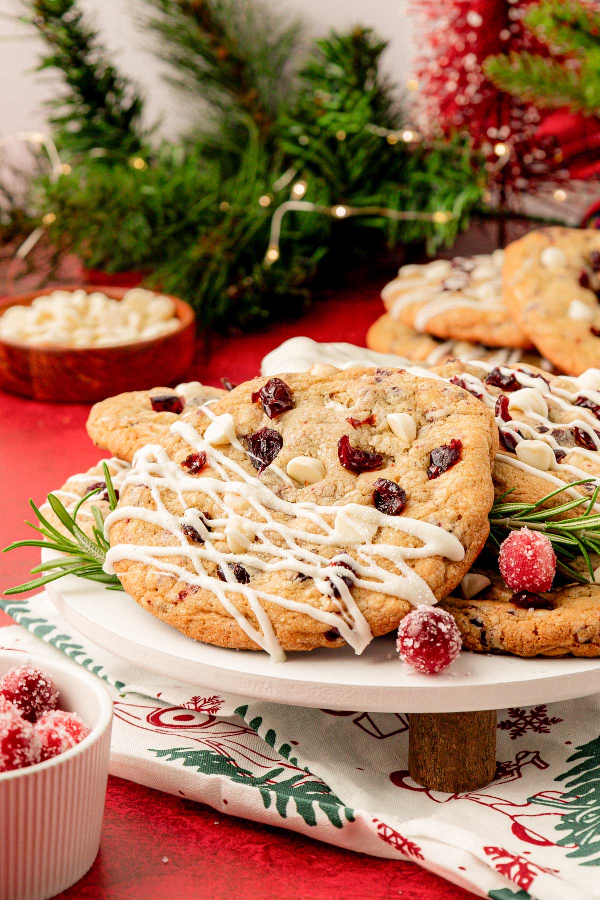 White chocolate cranberry cookies on a dessert stand.