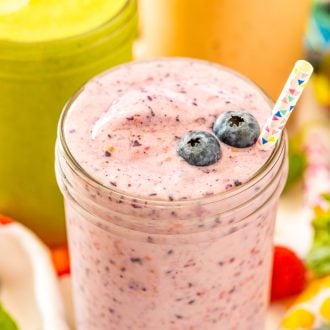 Close up photo of a smoothie with blueberries on it.