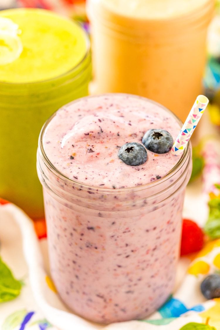 Close up photo of a smoothie with blueberries on it.