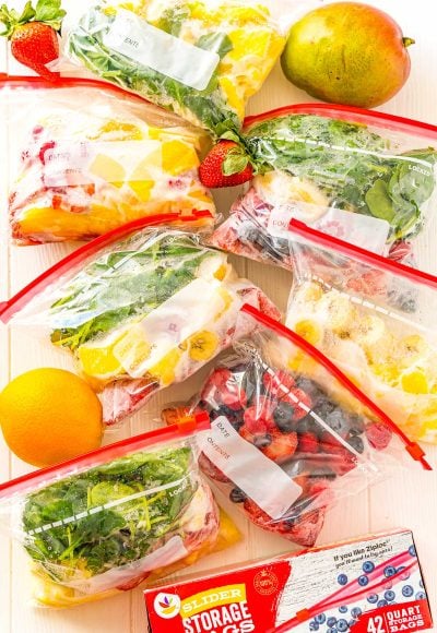 Frozen smoothie packs with fruit scattered around.