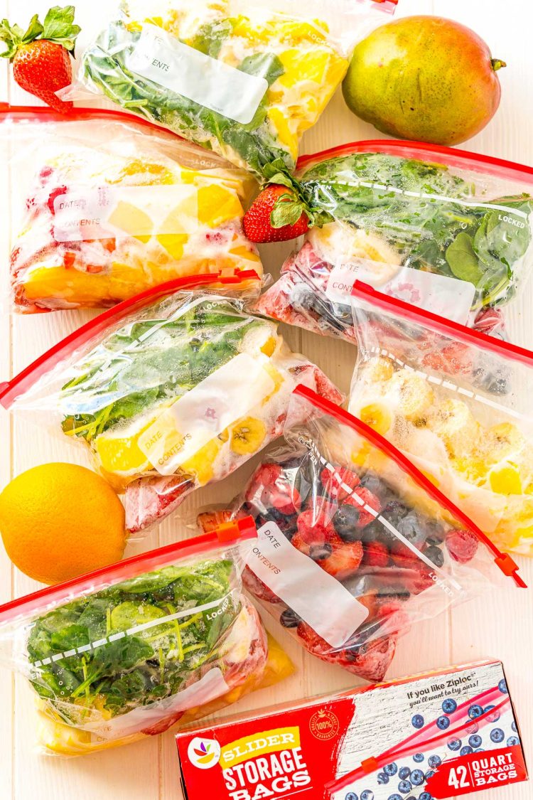 Frozen smoothie packs with fruit scattered around.