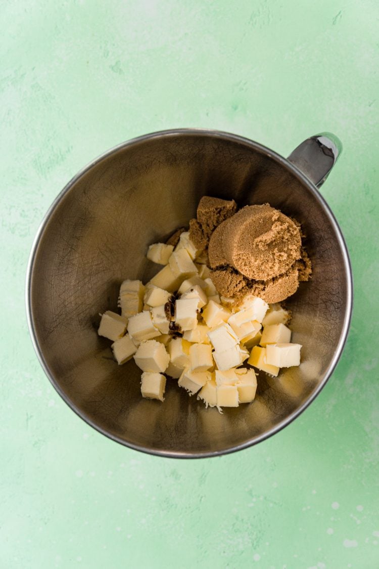 Butter and brown sugar in a metal mixing bowl.