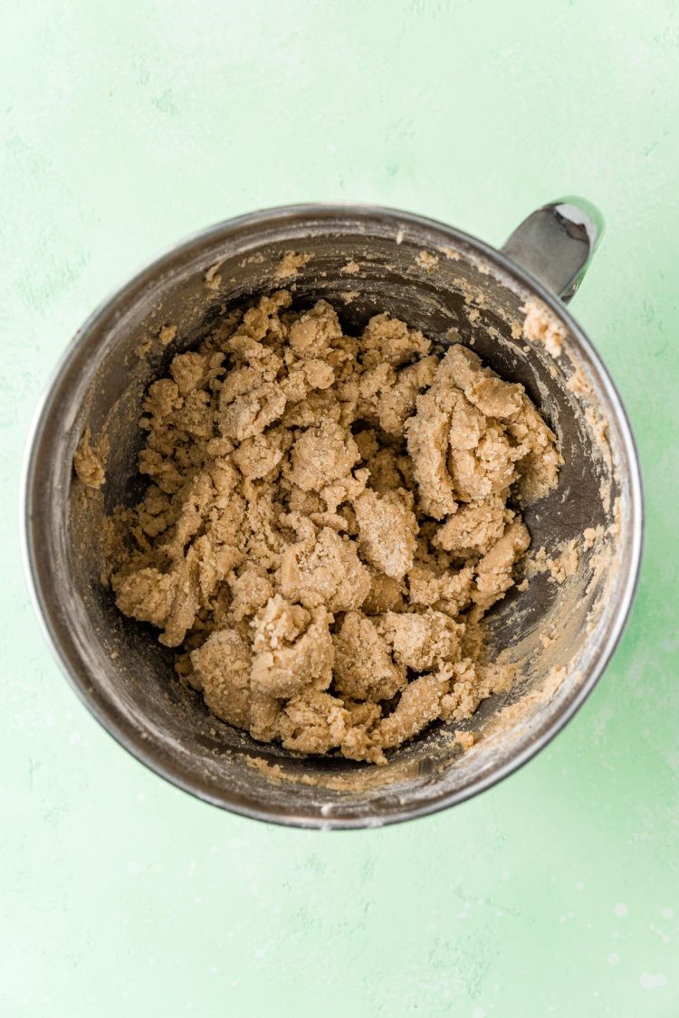 Overhead photo of cookie dough in a metal mixing bowl.