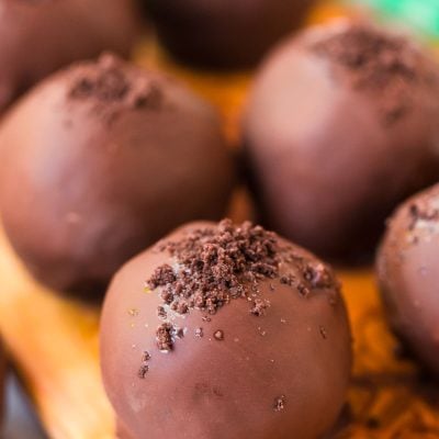 Close up photo of mint chocolate truffles on a wooden cutting board.