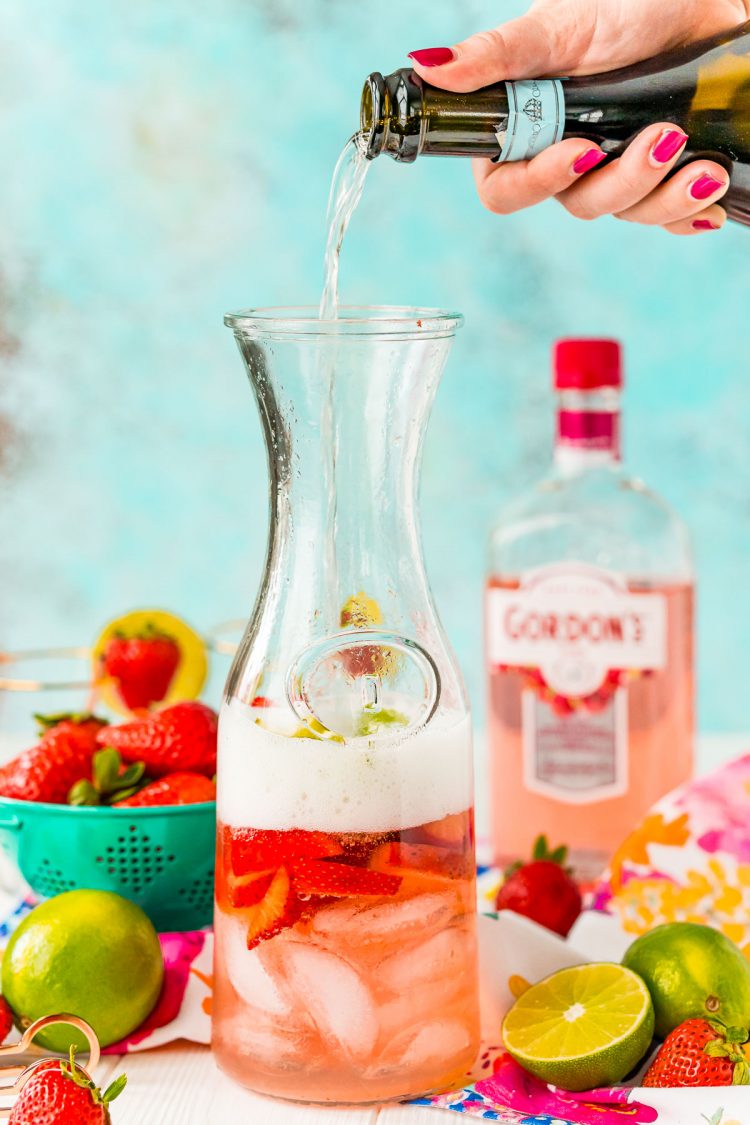 Prosecco being poured into a carafe.