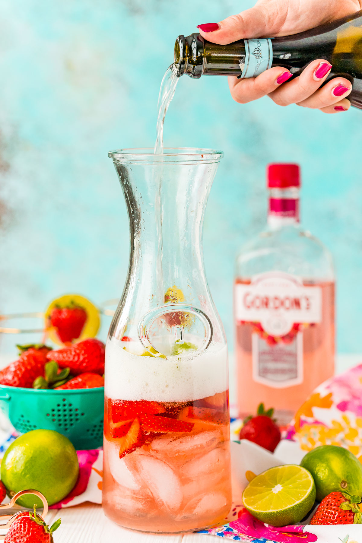 Prosecco being poured into a carafe.
