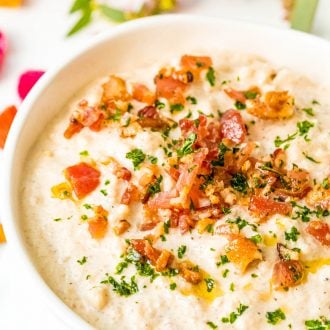 Close up photo of cauliflower chowder with bacon topping.
