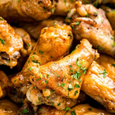 Chicken wings piled on top of each other in a bowl ready to eat.