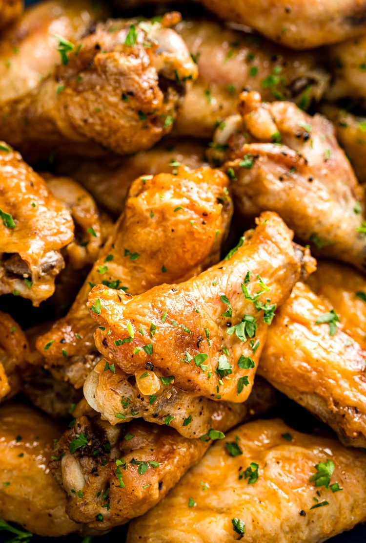 Chicken wings piled on top of each other in a bowl ready to eat.