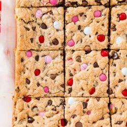 Overhead photo of a batch of slice chocolate chip cookie bars on parchment paper.