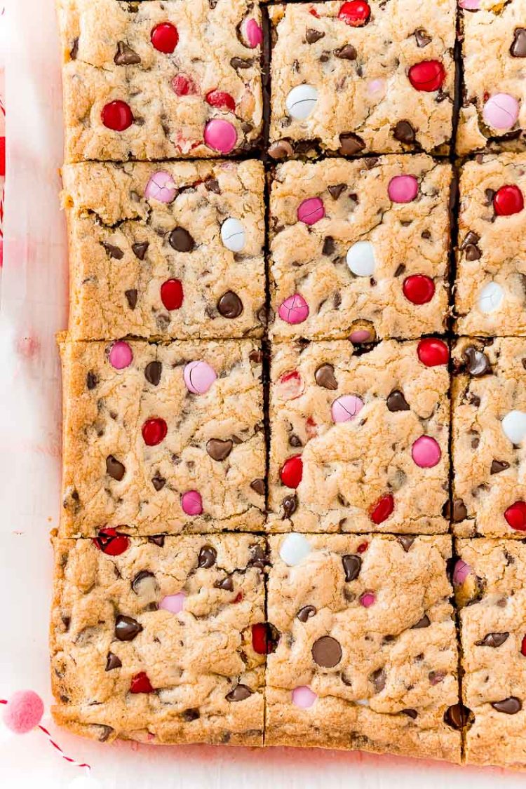 Overhead photo of a batch of slice chocolate chip cookie bars on parchment paper.