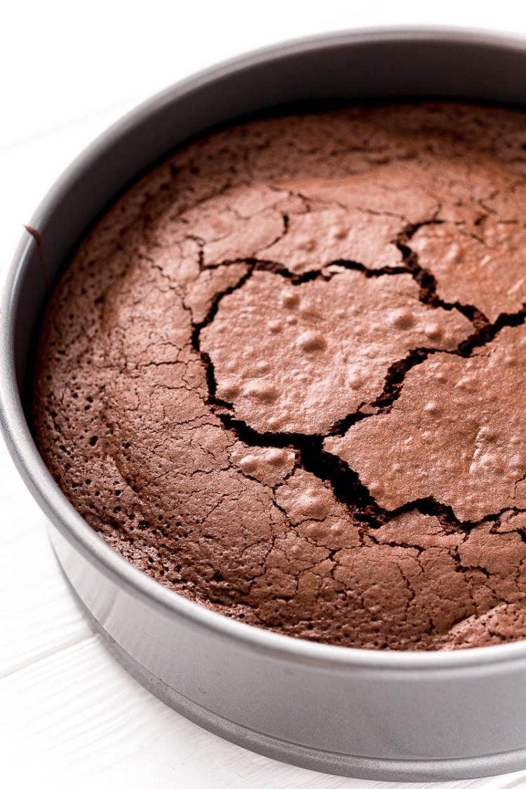 Close up photo of a flourless chocolate cake in the pan.