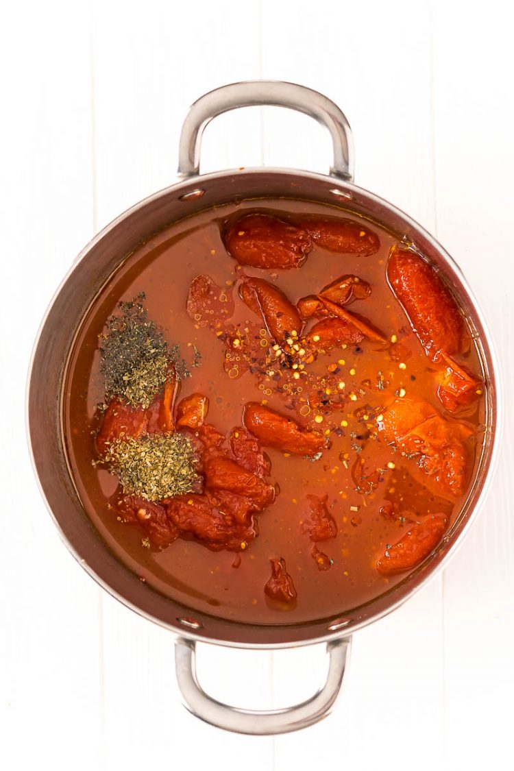 Ingredients to make marinara sauce in a large saucepan.