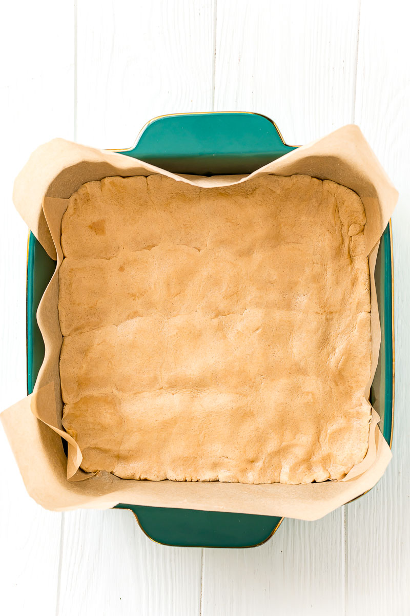 Overhead photo of a square baking dish filled with peanut butter cookie dough.