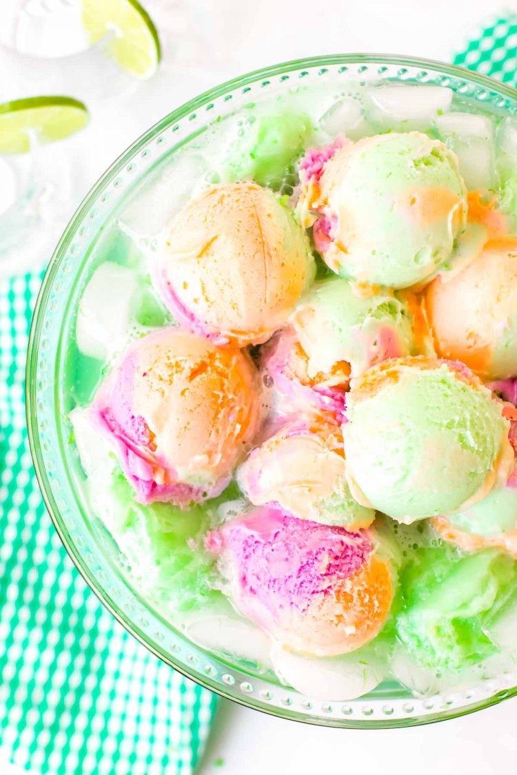 Overhead photo of a bowl of punch topped with rainbow sherbet.