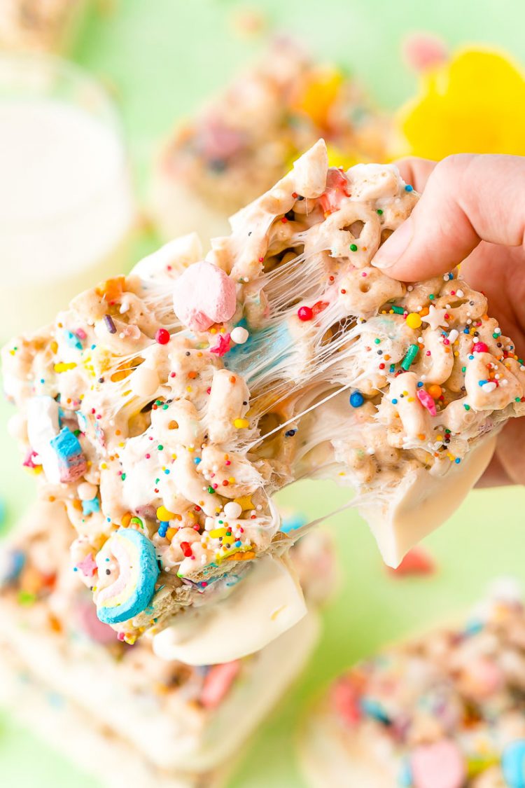 Lucky charms treat being ripped in half showing stretchy gooey marshmallow.