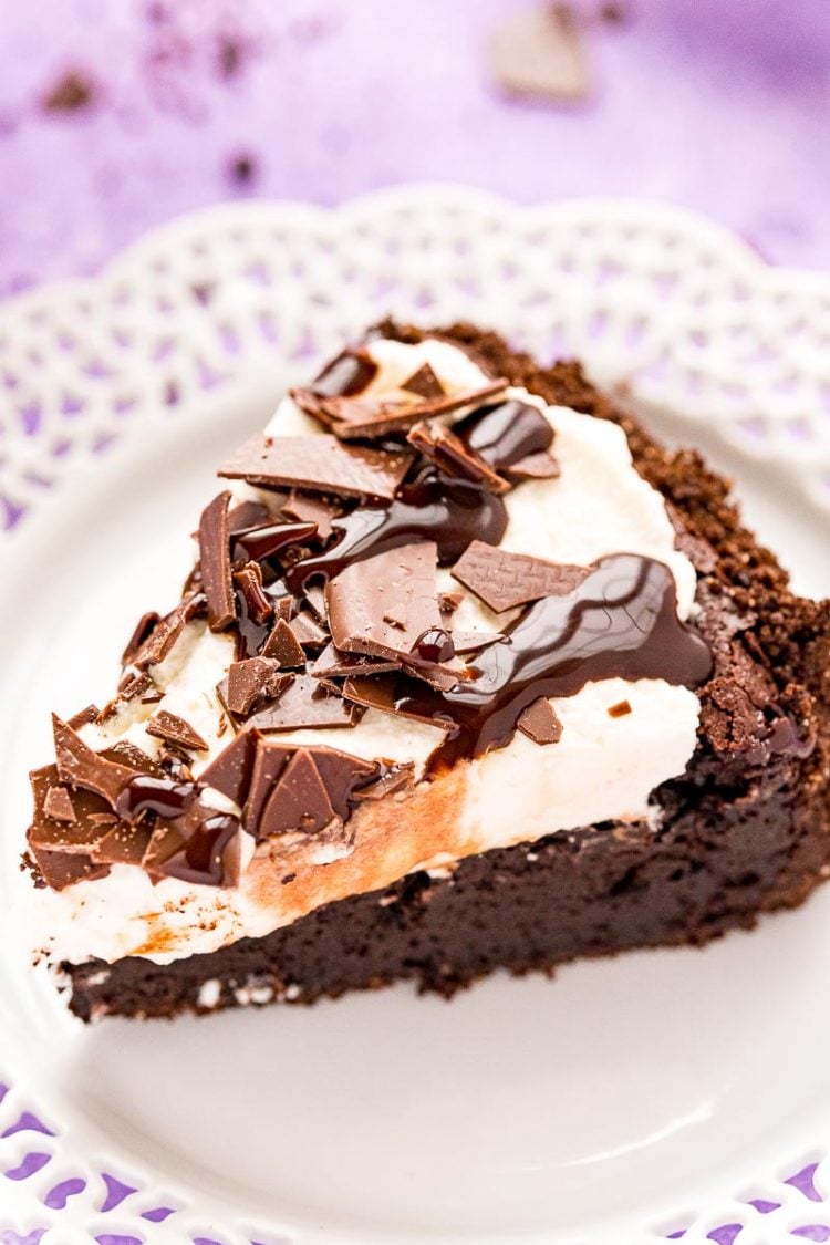 Close up photo of a slice of Mississippi Mud Pie on a white plate.