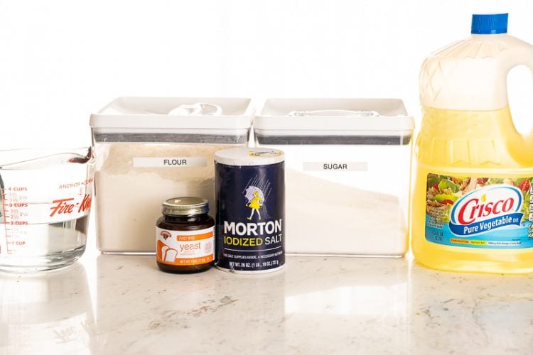 Ingredients to make bread on a marble table.