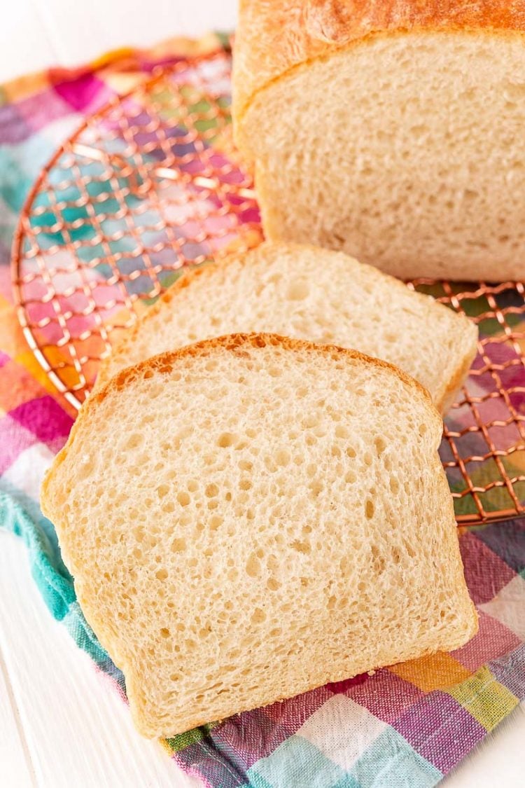 Slices of white bread on a colorful napkin.